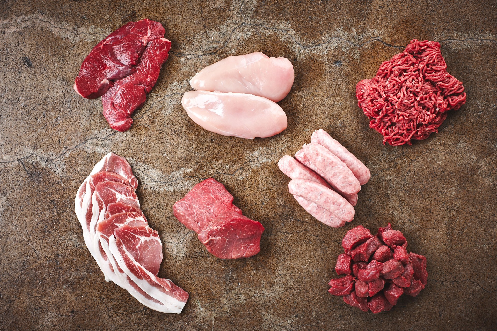 Top view, meat and chicken or food in butchery for catering, raw and protein for event, party or cooking. Selection, mince and sausage with nutrition for barbecue, lunch or brunch with fresh diet